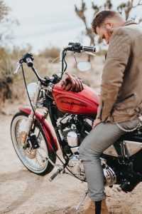 A person sitting on a parked motorcycle