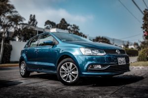 A blue sedan parked in a driveway